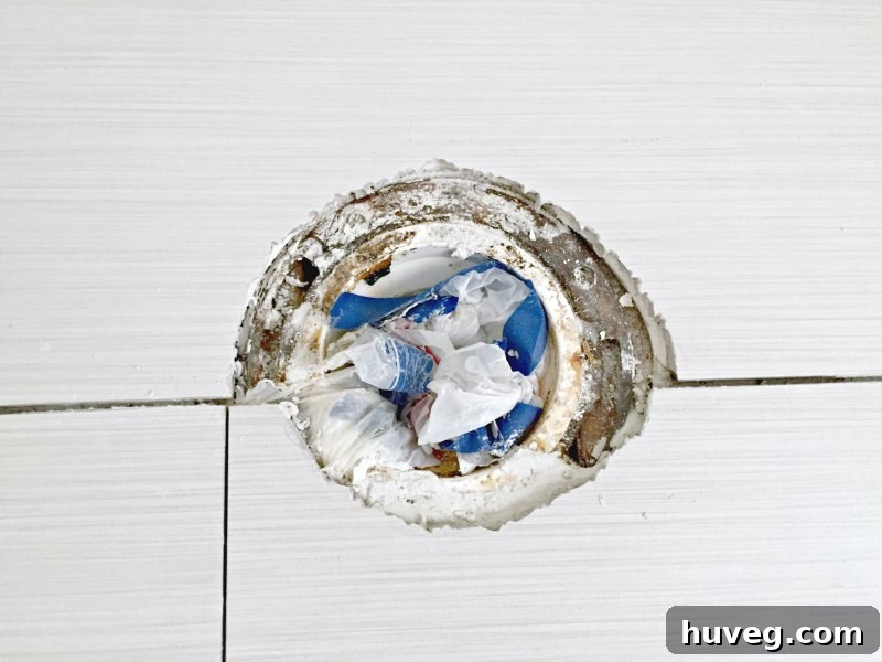 Incorrect tile cut around toilet flange