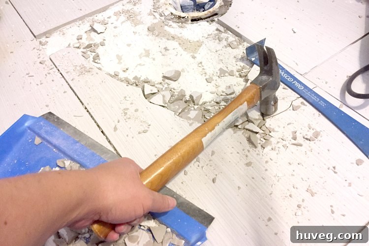 Repeat hitting tile in the same spot until it cracks