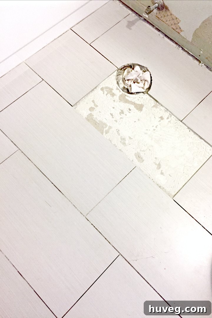 Removed tile near toilet flange, preparing for new installation