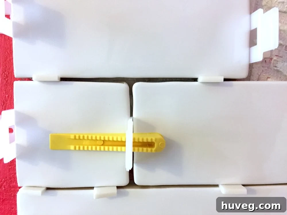 Tiling a tub surround in a master bath, showing use of QEP tile leveling spacers