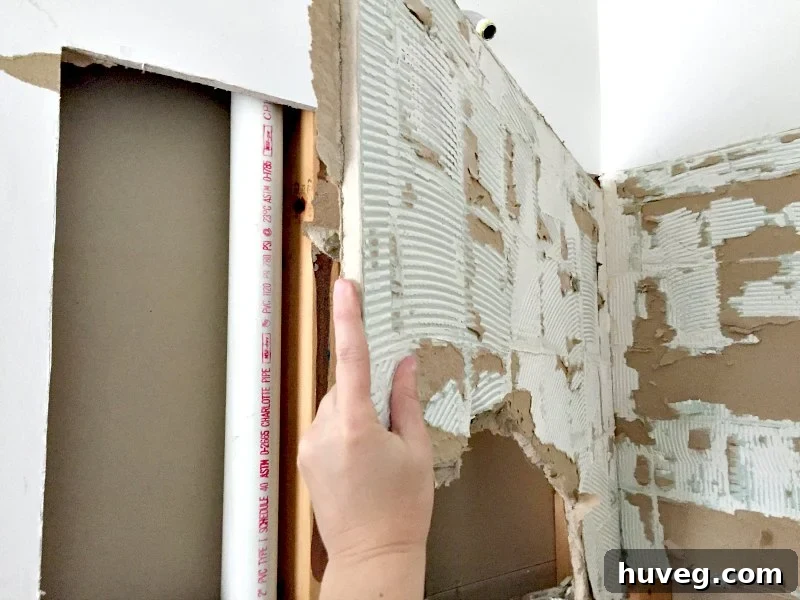 Removing old drywall in large chunks during shower renovation