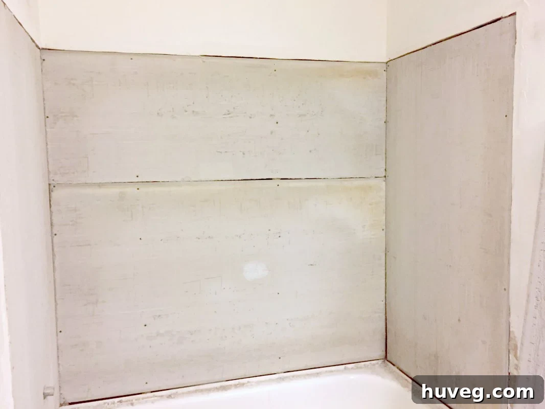 Cement backer board installation for a shower surround, showing proper placement