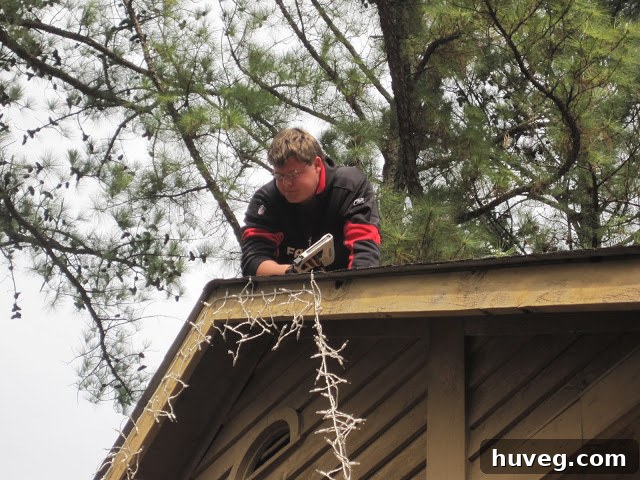 Scott climbing a ladder to access the second-floor roof