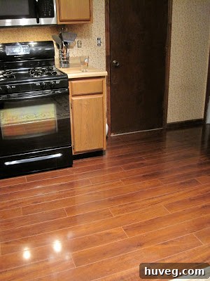 Another view of the transformed kitchen, featuring improved lighting and clean, expansive countertops.