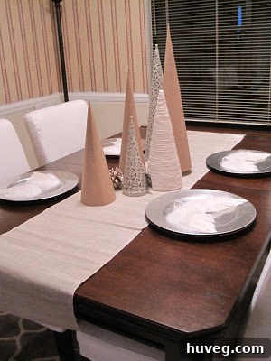 Collection of pale holiday decorations with yarn tree and silver accents