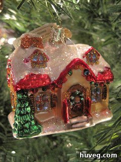 Two charming ornaments, one shaped like a cozy house and another like a tiny key, symbolizing the joy of a first home and new beginnings.