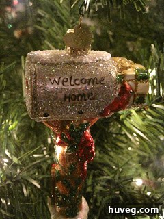 A festive ornament depicting a couple celebrating, perhaps marking an engagement or wedding, signifying shared happiness.