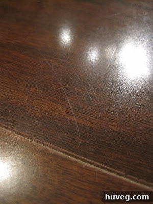 A wider view of the kitchen floor showing numerous scratches