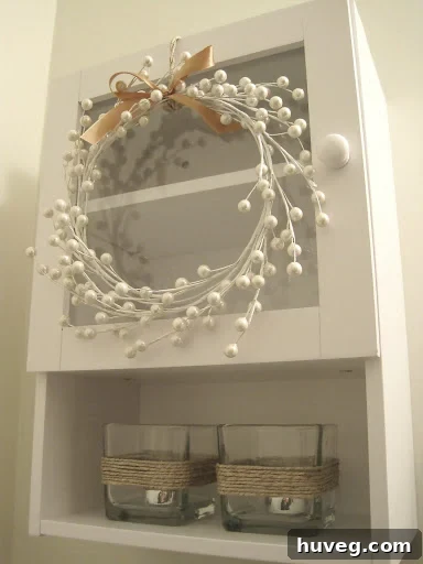 White berry stem wreath on cabinet