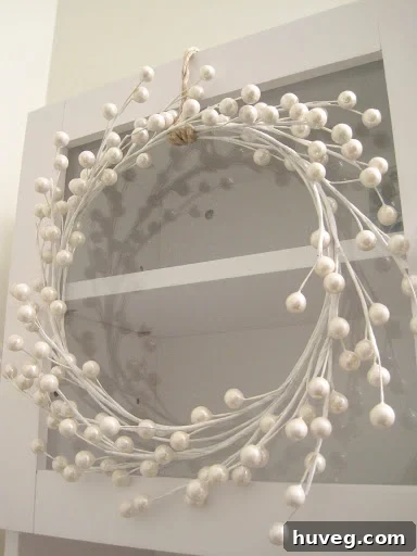 White berry stem wreath on cabinet