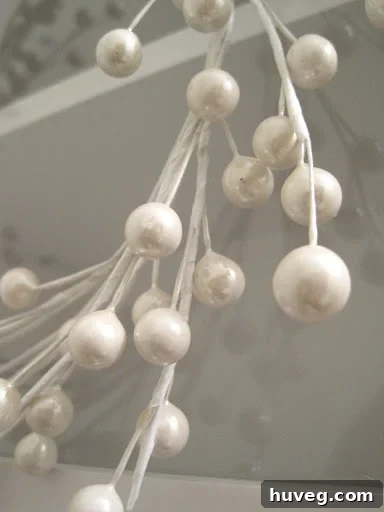 White berry stem wreath on cabinet- close up