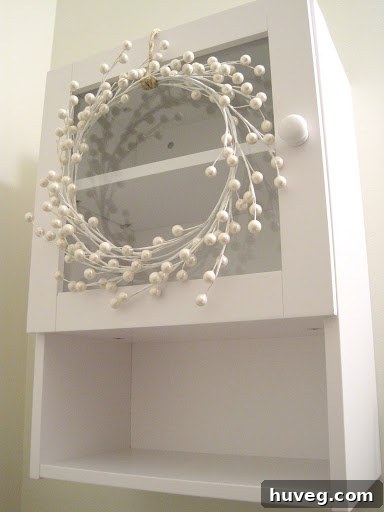 White berry stem wreath on cabinet