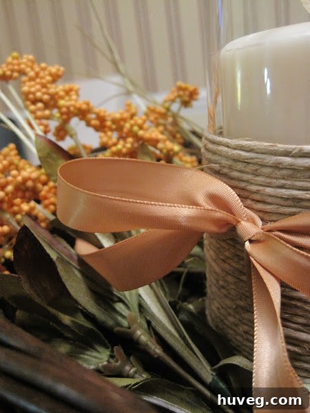 Close-up of the rustic Thanksgiving centerpiece with twine-wrapped candle holder