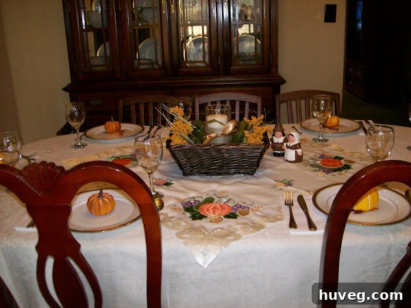 Thanksgiving table setting with a small pumpkin on each plate