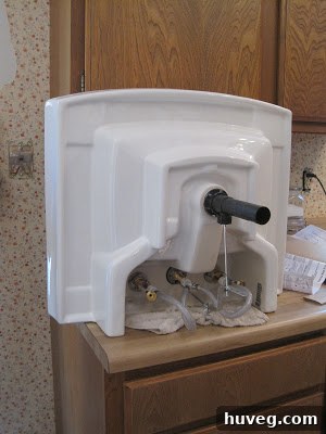 Installation of the new pedestal sink in the powder room.