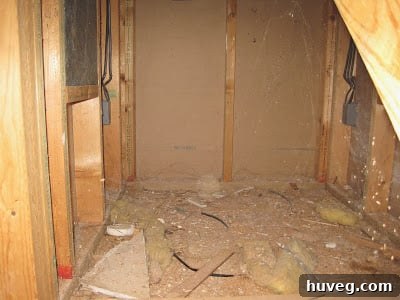 An unfinished or poorly constructed area under a set of stairs, symbolizing hidden construction flaws.