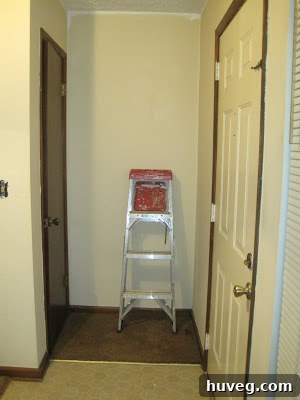 Before photo of the entryway with old flooring.