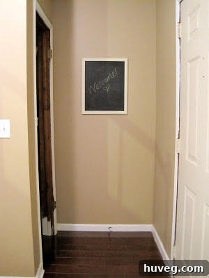 After photo of the entryway with new laminate flooring installed.