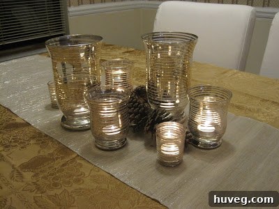 Soft glow of votives amidst shimmering candle holders and natural pine cones