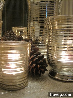 Close-up of natural pine cones nestled among festive candle holders