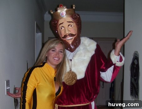 A couple dressed as Beatrix Kiddo from Kill Bill and a homemade Burger King for Halloween.