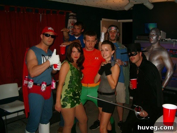 A group of friends at a Marvel Madness party dressed as various superheroes and villains, including Poison Ivy, Duffman, Aquaman, and Zorro.