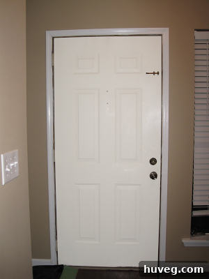 Front door painted white, matching interior trim