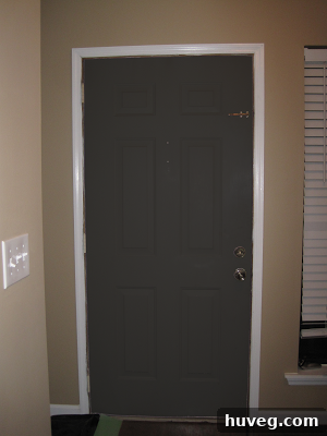 Front door painted black for a bold interior statement