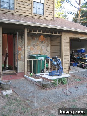 Linoleum sheets being cut with tools in front of the house.