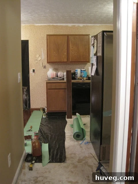 Close-up of kitchen floor underlayment being weighed down.