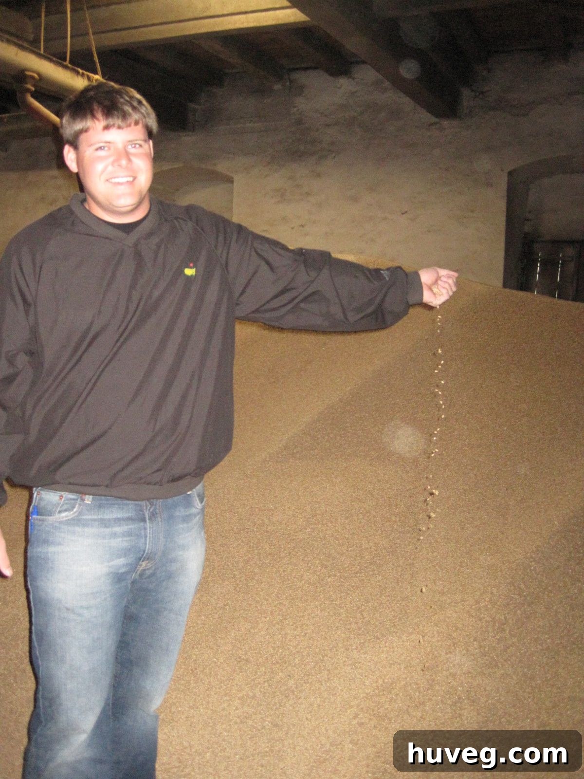 Scott admiring a large mound of malted barley