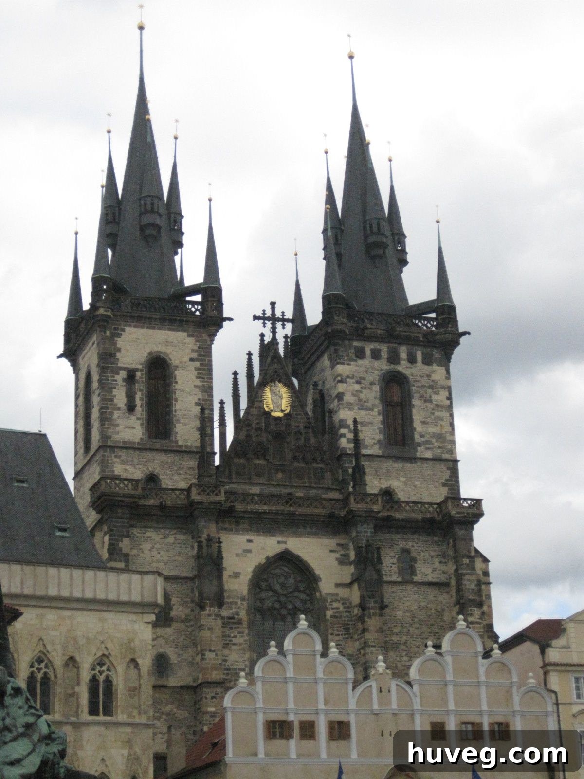 A panoramic view of the majestic Vltava River winding gracefully through Prague, flanked by historic architecture and the iconic Charles Bridge.