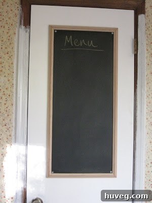 Finished chalkboard frame attached to a pantry door, showing the painted door and surrounding trim.