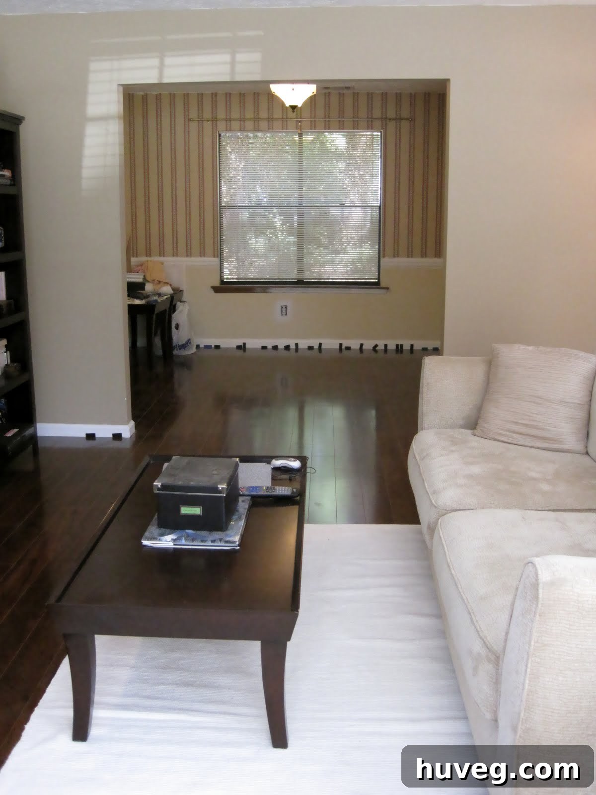 Seamless flow of new laminate flooring between living and dining rooms