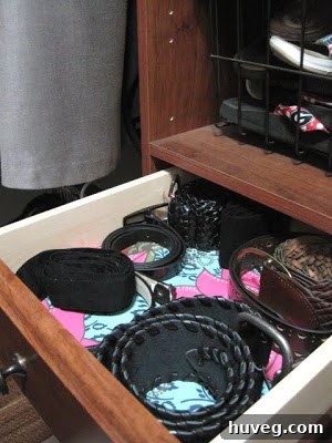 After image of a neatly organized drawer for belts with decorative lining