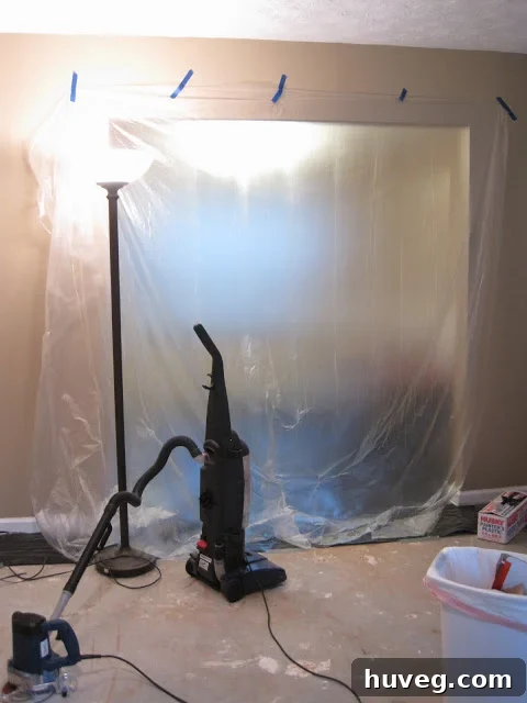 Room protected with plastic sheeting before cutting begins