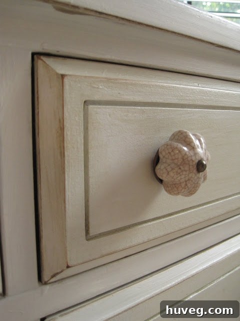Detail shot of the new pale gray dresser's top drawers and decorative pulls