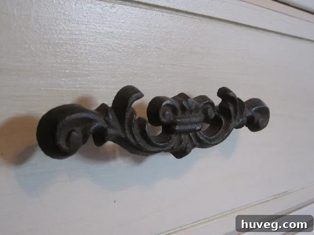 Close-up of the lower drawers of the dresser with original iron handles