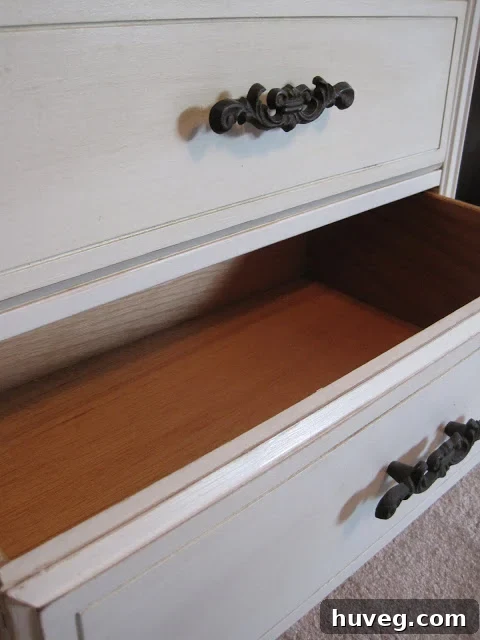 Open drawer of the pale gray dresser, showing interior space