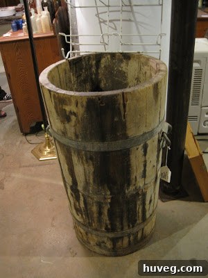 A rustic old wooden water barrel.