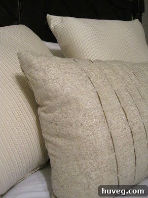 Close-up of a silver-threaded accent pillow, highlighting its texture.