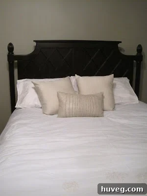 A beautifully styled bed with a new white and burlap duvet cover, showcasing pillows and textures.