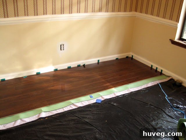 Laminate flooring being installed in a dining room near a stone fireplace hearth, highlighting a common DIY challenge