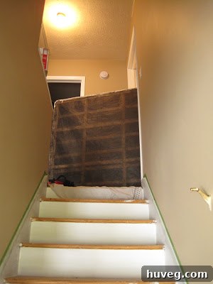 Carpet installers working diligently, unrolling and laying down new carpet in a bedroom.