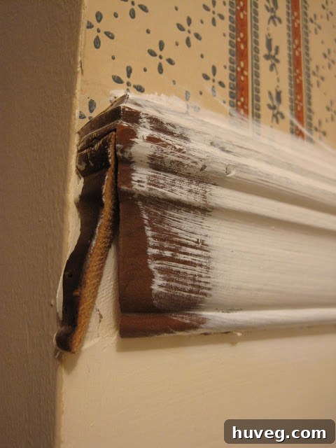 Close-up of a chair rail with a small gap where trim was loose