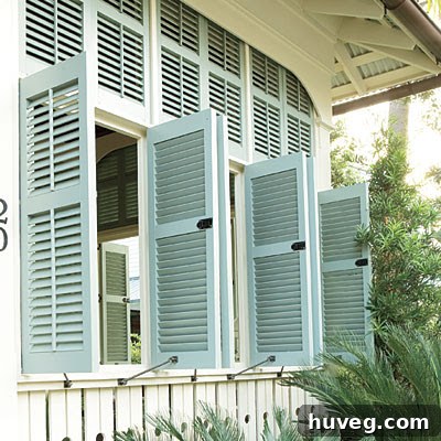 Close-up of classic white plantation shutters on a coastal-style home