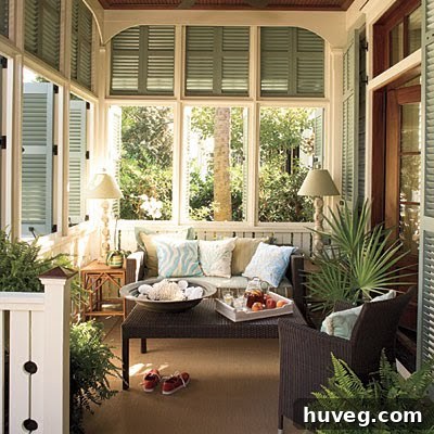 Inviting coastal front porch with comfortable seating, throw pillows, and light decor