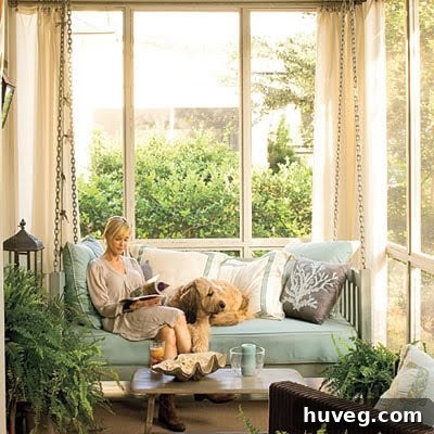 Relaxing back porch or sunroom decorated in coastal style with comfortable furniture and natural light