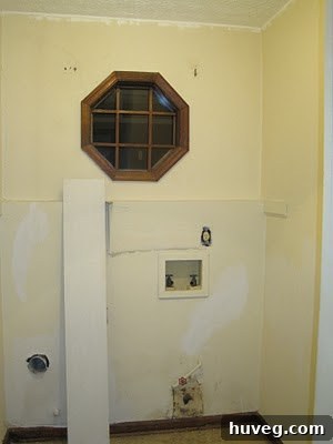 Before photo of a cluttered and uninspiring laundry room