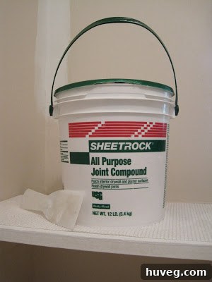 Image showing joint compound applied to a patched wall during laundry room renovation